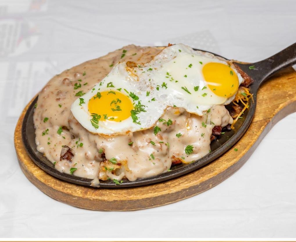 Breakfast skillet with sausage gravy and sunny-side-up eggs